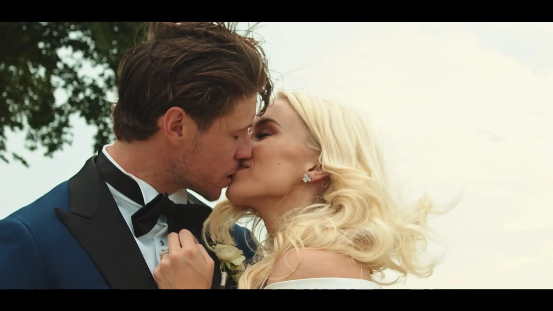 Newly married couple kissing outdoors